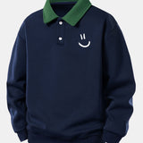 Velira Sweatshirts Jūros mėlyna / XS Atsipalaidavusio kirpimo šypsenėlės printo kontrastingas polo džemperis